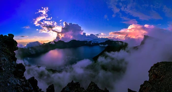 Dramatic clouds parting over Heaven Lake crater at Mount Paektu